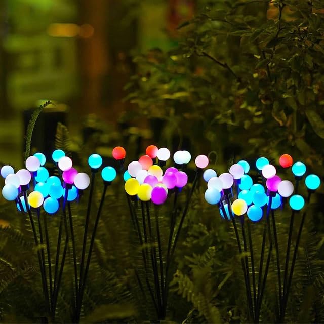 Colorful solar garden lights brightening up an outdoor space after sunset.