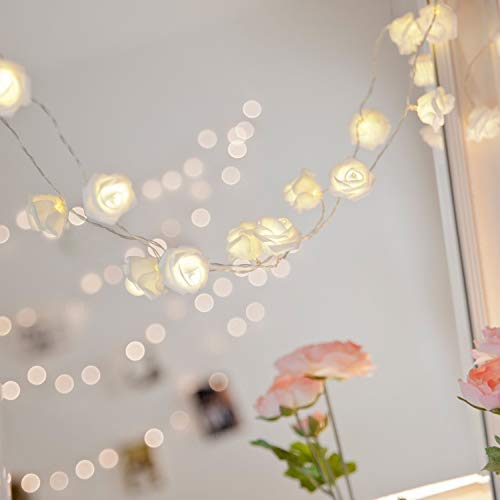 White rose lights on rustic wooden table