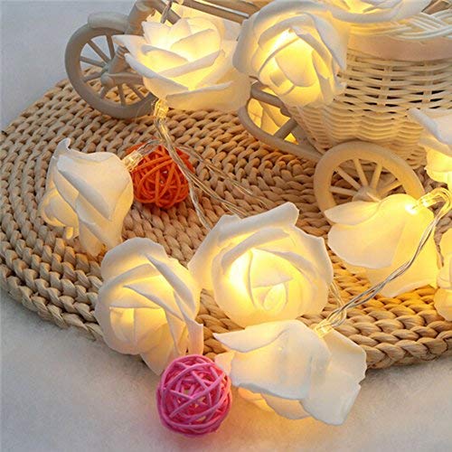 White rose string lights on wooden table