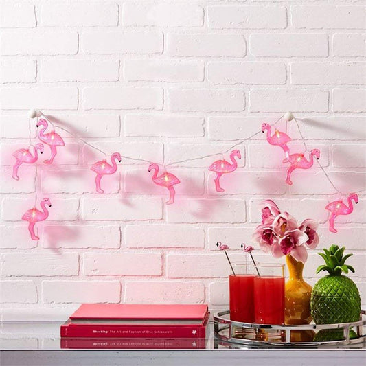 A vibrant display of flamingos adorned with pink lights, creating a whimsical and festive atmosphere.