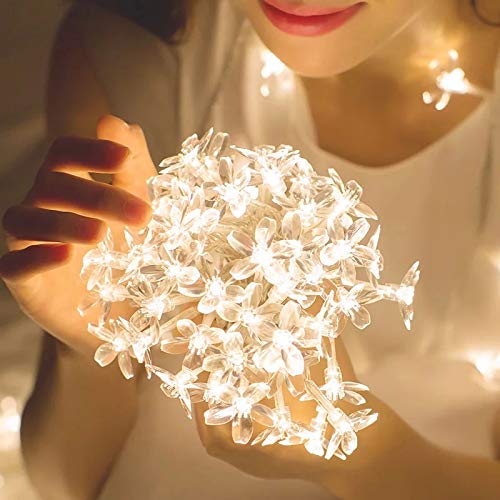 Lady holding white floral arrangement.