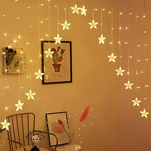 Person showcasing a star-shaped string light, illuminating the space with a magical touch.