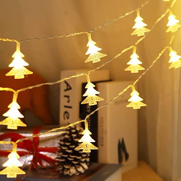 Christmas lights hanging on trees in a festive display.