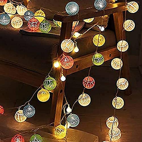  Colorful balls displayed in a glass vase.