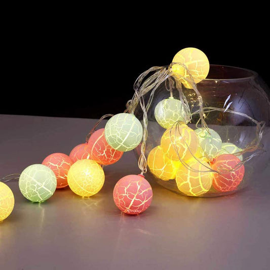 Colorful balls inside a glass vase.
