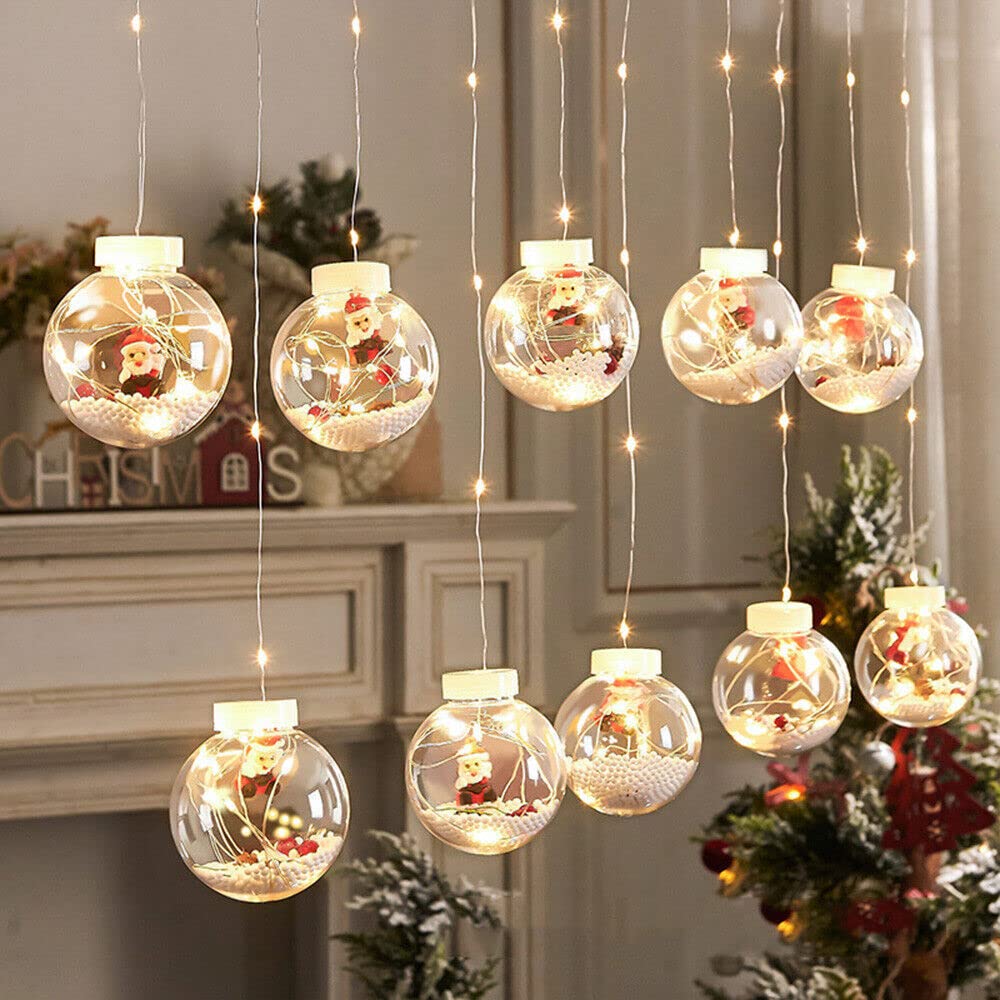 A festive Christmas ball hanging from the ceiling, adorned with twinkling lights.