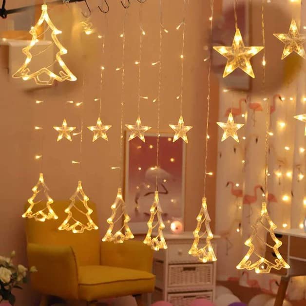 A room adorned with string lights and Christmas trees, creating a warm and festive atmosphere.