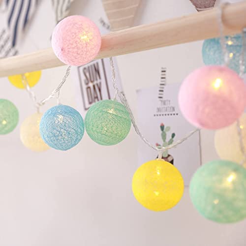 Colorful ball string lights hanging on a wall, adding a festive touch to the room decor.