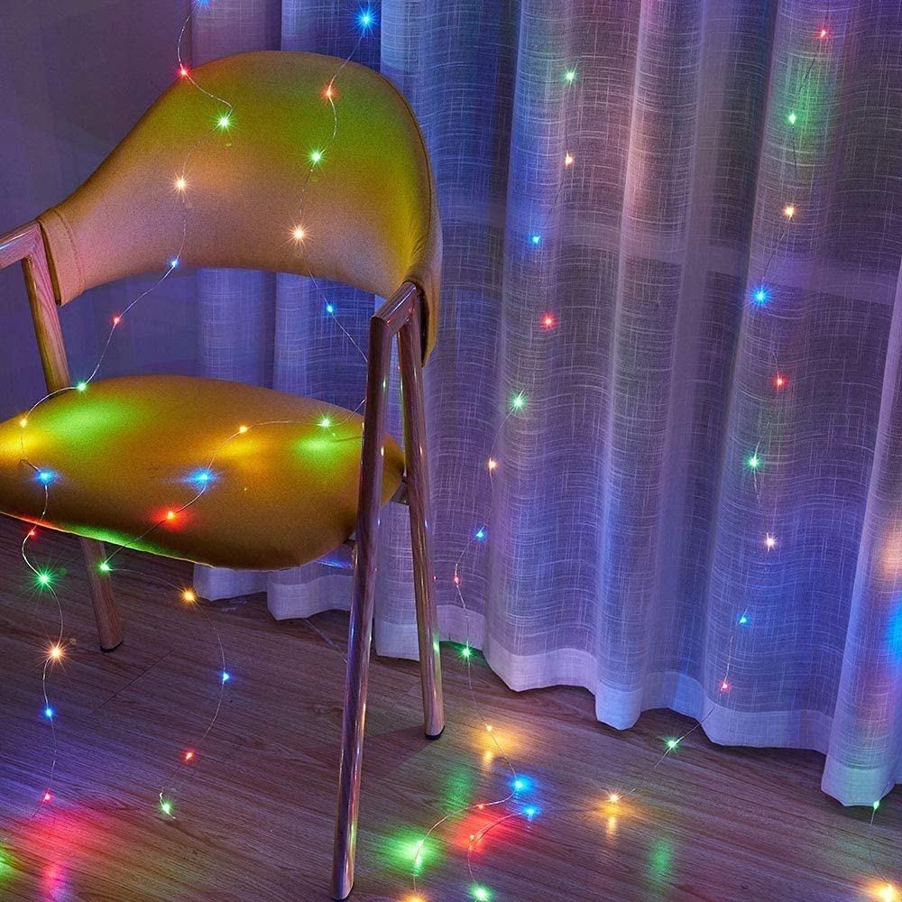 Vibrant lights illuminating curtains in a room.