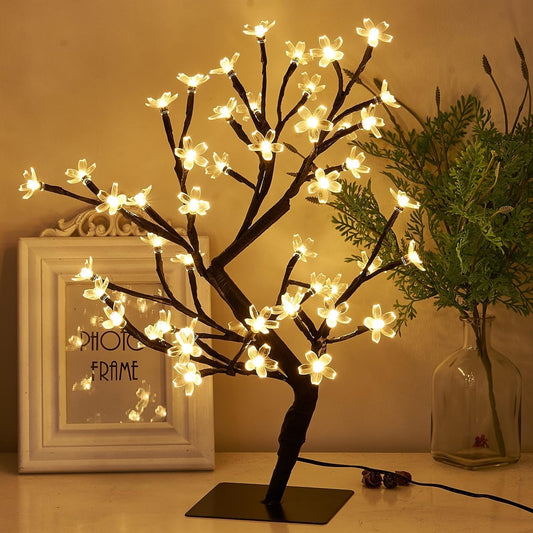 Small tree with glowing lights and delicate flowers.