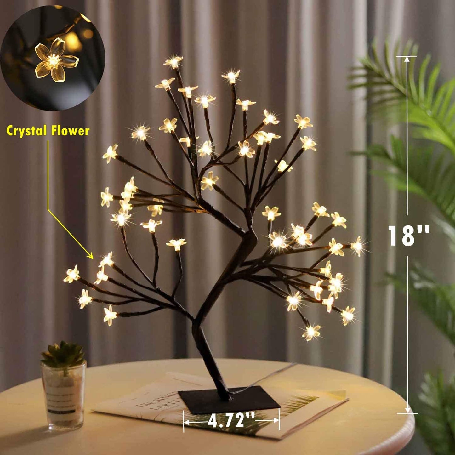 Small crystal tree adorned with twinkling lights.