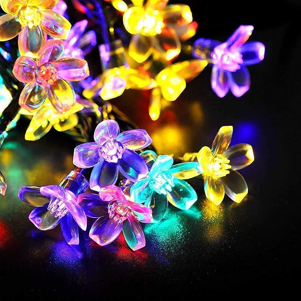 A beautiful display of colorful flowers enhanced by sparkling lights, showcasing nature's beauty in a magical way.