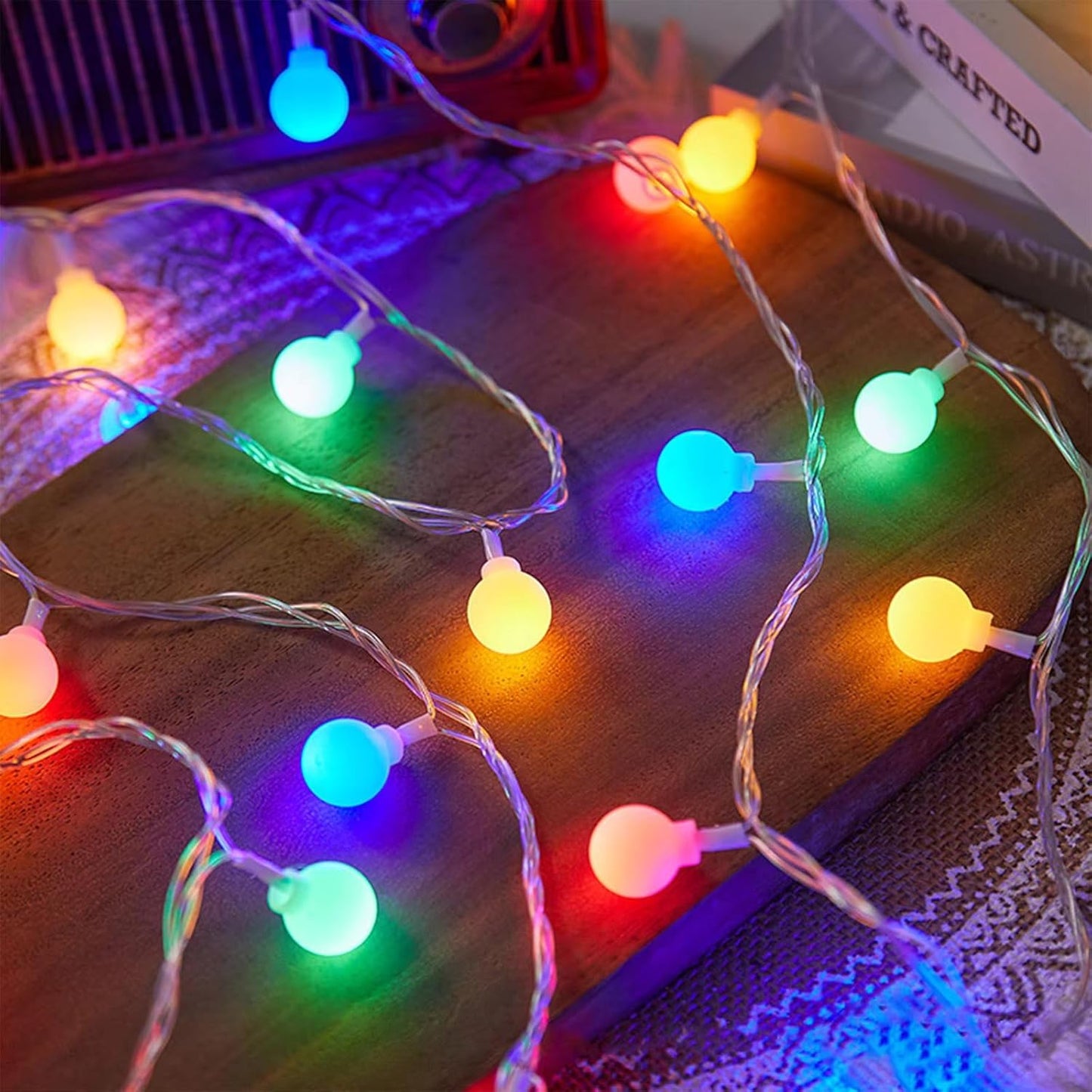 A cheerful assortment of Christmas lights shining on a white fence, contributing to a warm and festive ambiance.