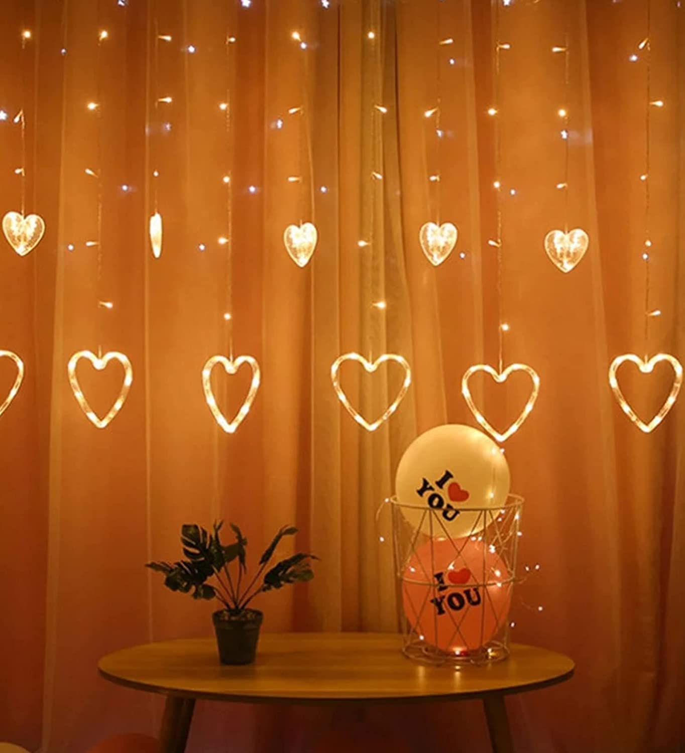 A room with heart-shaped curtain and twinkling lights.