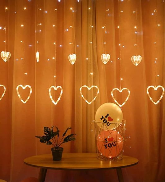 A room with heart-shaped curtain and twinkling lights.