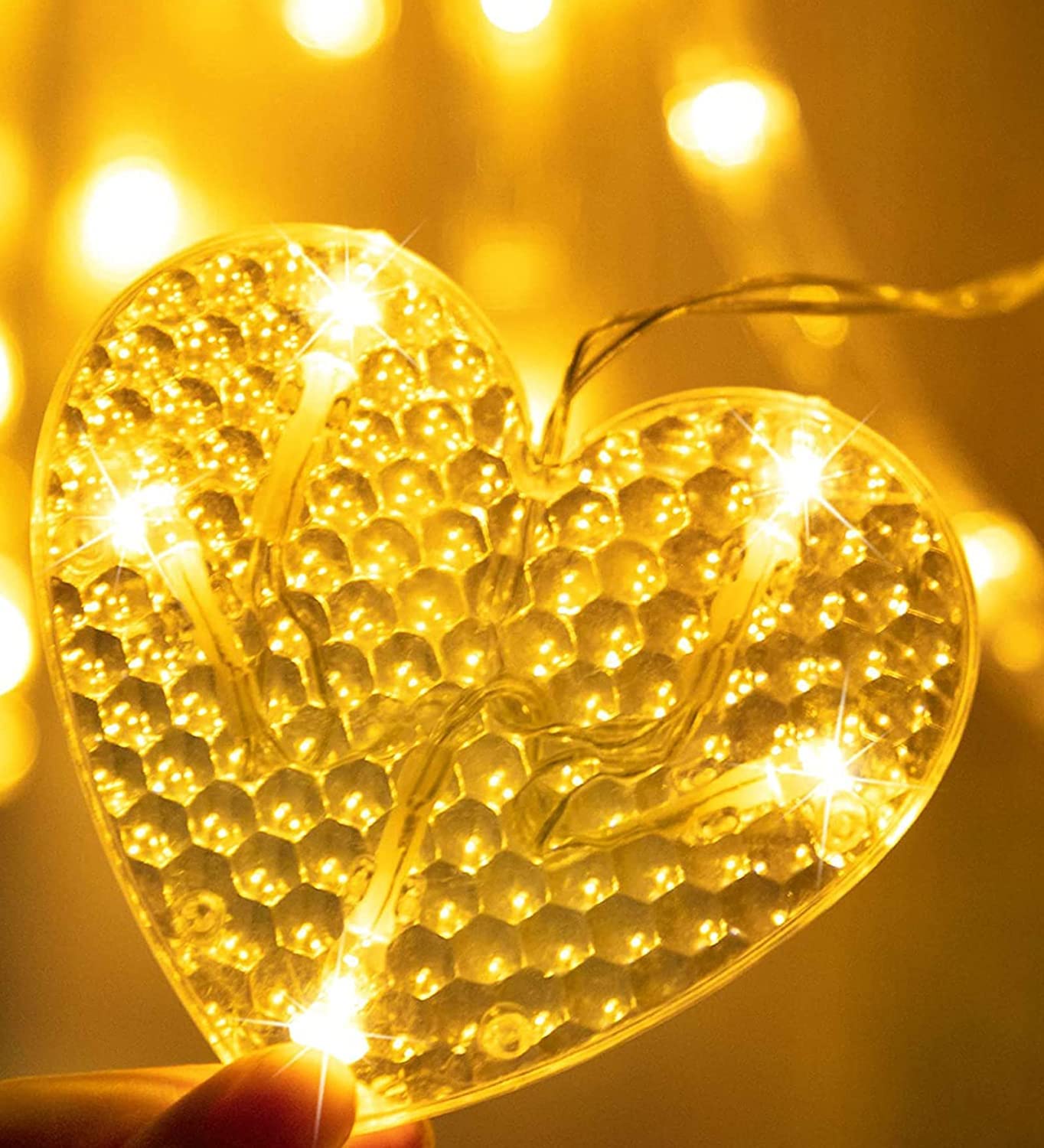 Glowing heart shape enclosed in glass vase.