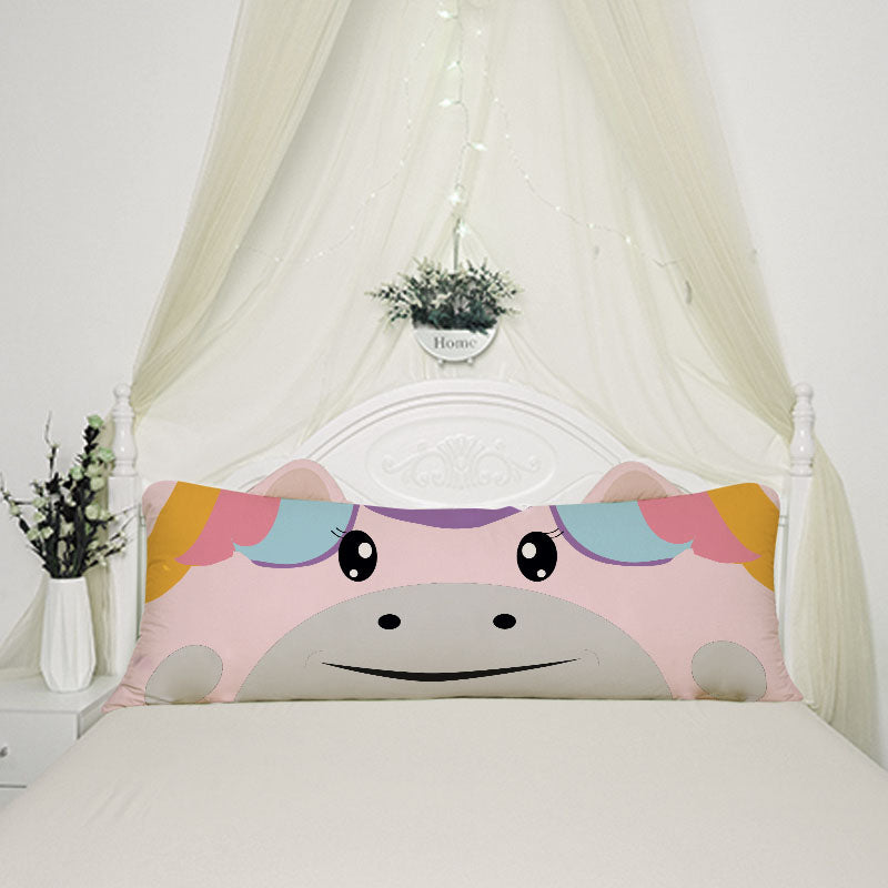 A pink unicorn pillow with a rainbow face on it, perfect for adding a touch of magic to any room.