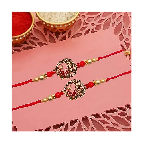Two red rakhi with gold beads and a gold coin, traditional Indian symbols of love and protection.