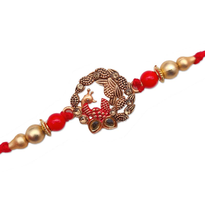 Festive red and gold rakhi adorned with a beautiful gold and silver bird design.