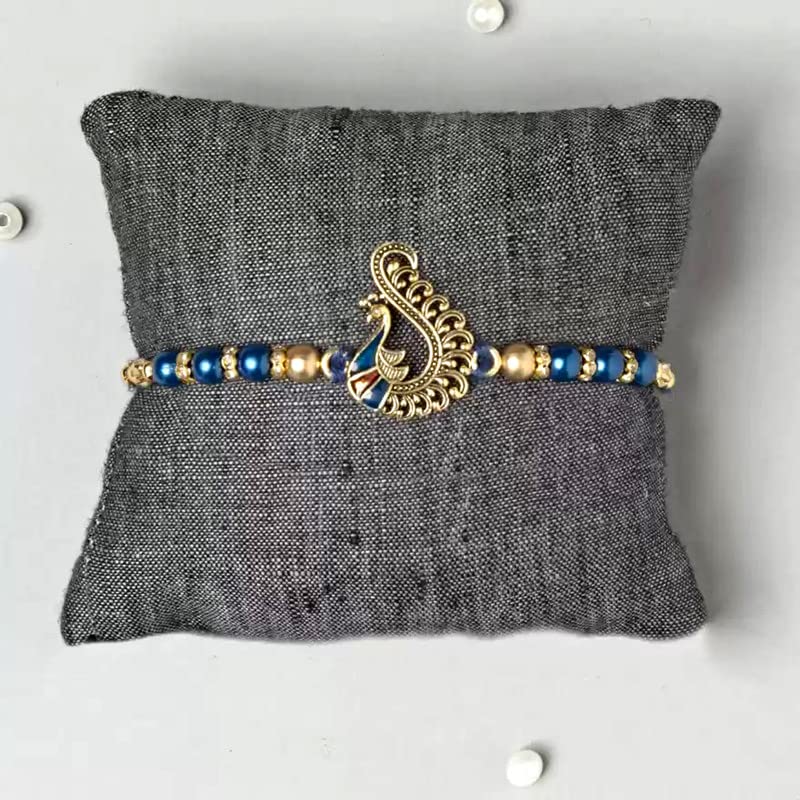 Traditional rakhi adorned with blue beads and gold thread, representing a sacred bond.