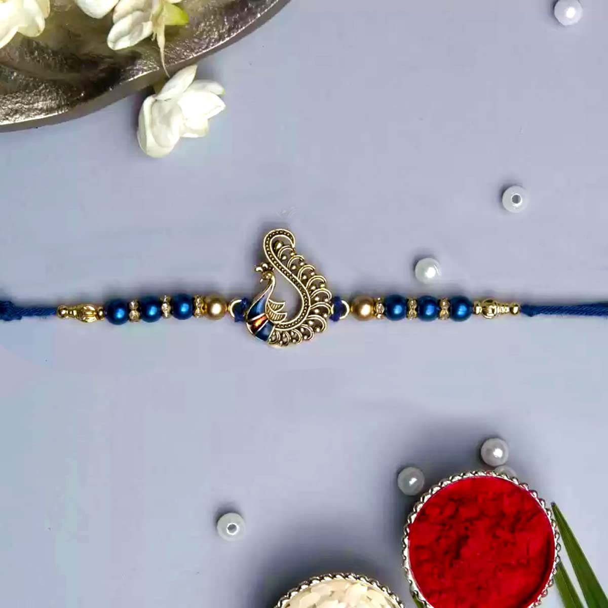 Elegant blue rakhi featuring a beautiful peacock design, ideal for Raksha Bandhan