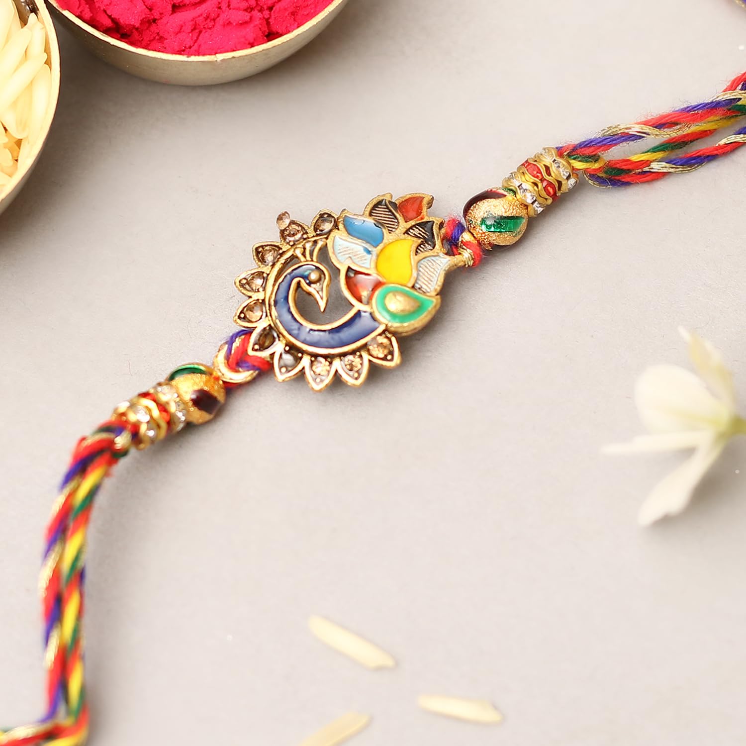  Vibrant rakhi featuring a combination of gold and red threads, representing the bond between siblings on Raksha Bandhan.