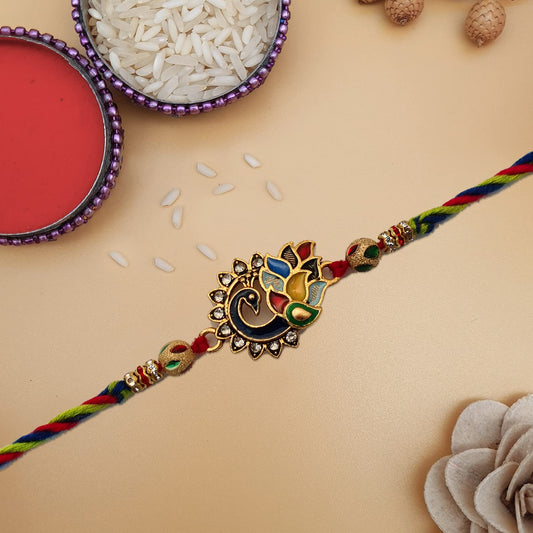  Rakhi adorned with a striking gold and red pattern.
