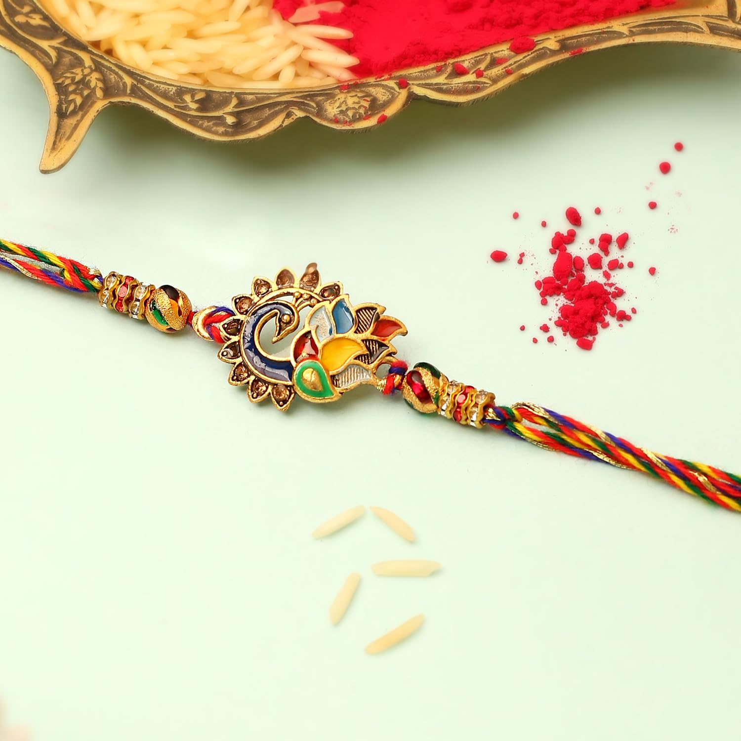 A vibrant rakhi with gold and red pattern.