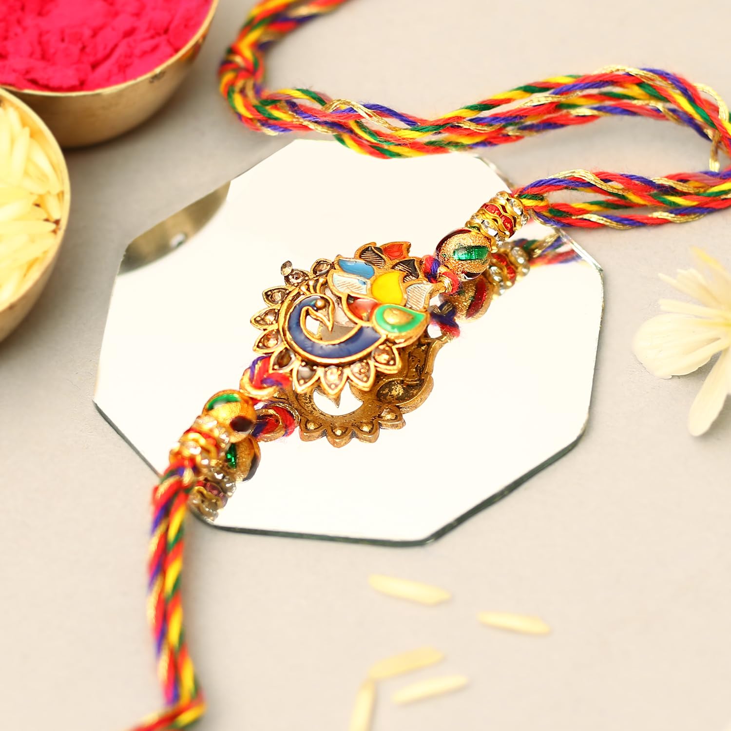 A colorful rakhi featuring gold and red design.