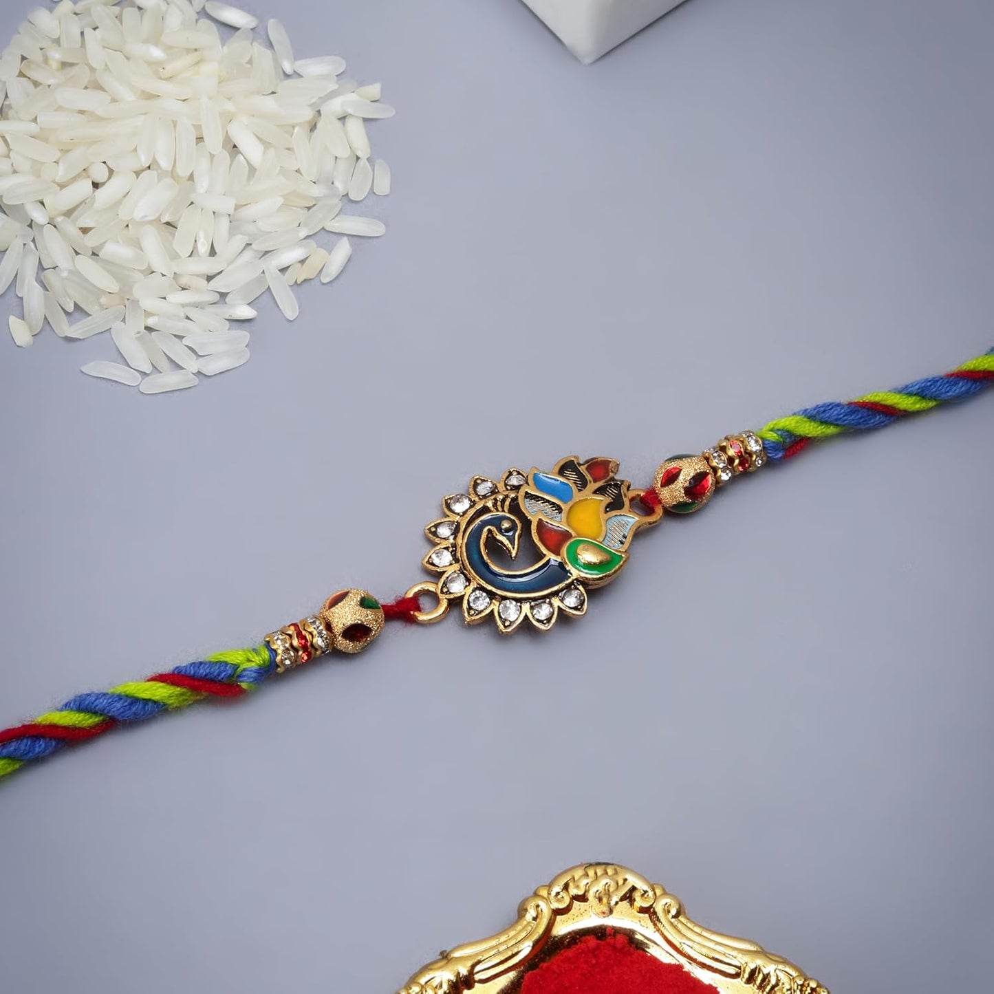 Festive rakhi featuring gold and silver beads, a must-have for Raksha Bandhan.