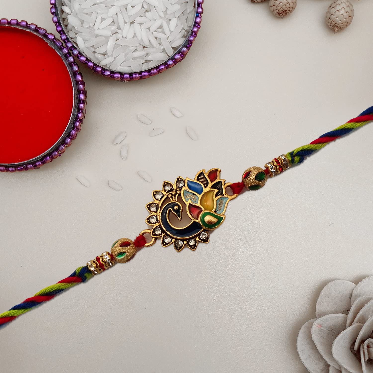 Traditional rakhi with a splash of colors and a gold and red thread.