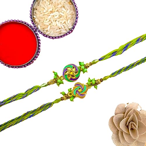 Two rakhi's with a flower and a red box