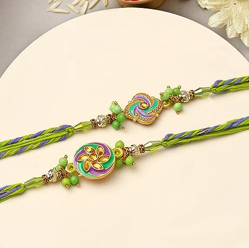 Green and purple rakhi's with a gold chain, traditional Indian bracelets exchanged during the festive occasion of Raksha Bandhan.