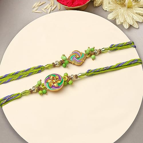 Vibrant green and purple rakhi's with a gold chain, traditional Indian bracelets exchanged during Raksha Bandhan.