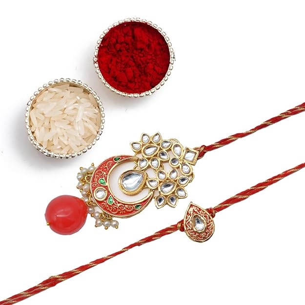 Beautifully crafted red and white rakhi with intricate gold and white stones, designed for bhaiya bhabhi rakhi.