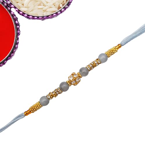  Rakhi with a gold and silver bead, a traditional symbol of sibling bond and protection.