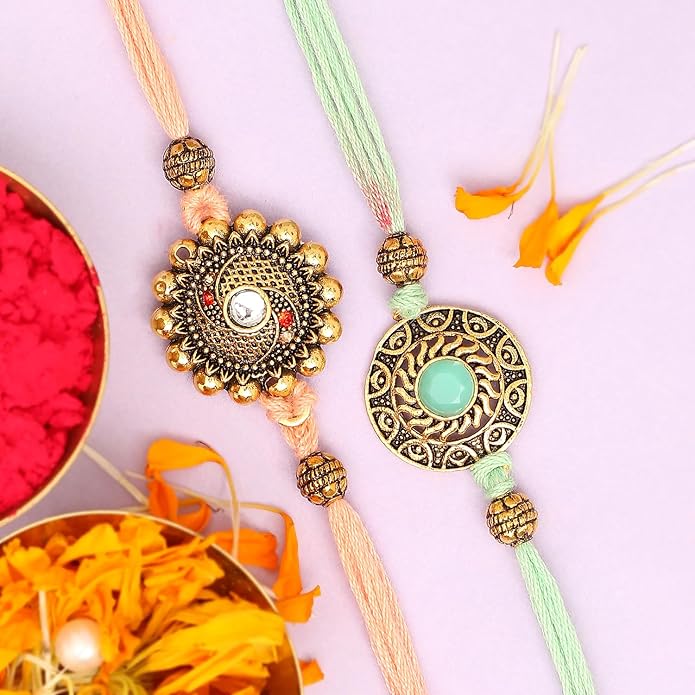 Two rakhi  featuring intricate gold and green threads, symbolizing love and protection between siblings.