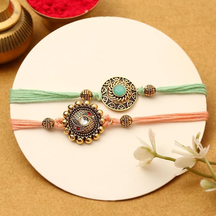  A pair of rakhi  made with vibrant gold and green threads, representing the bond of sibling love and care.