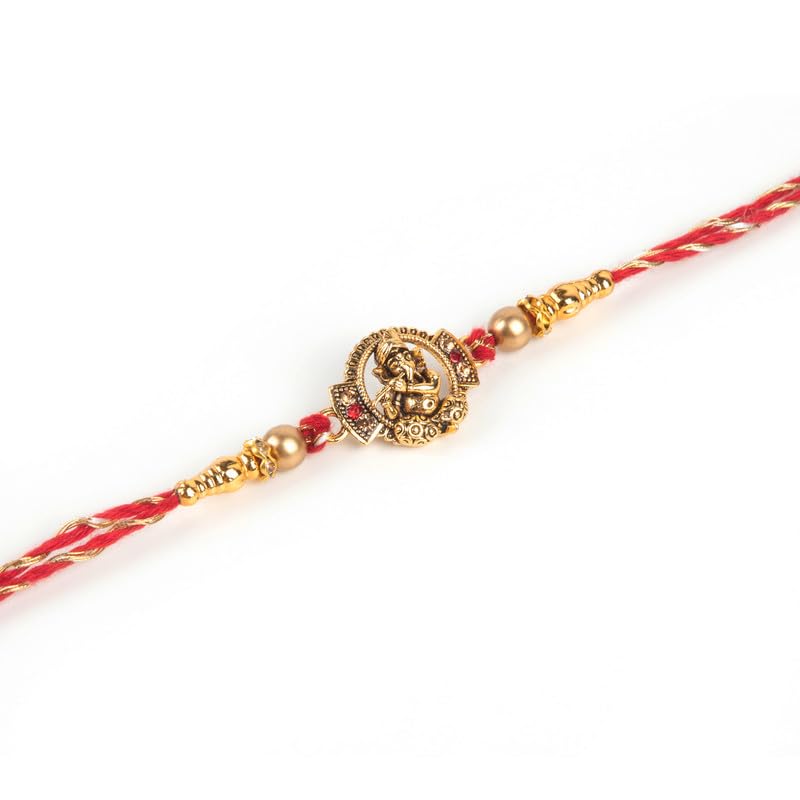 A gold rakhi bracelet adorned with a Hindu god.