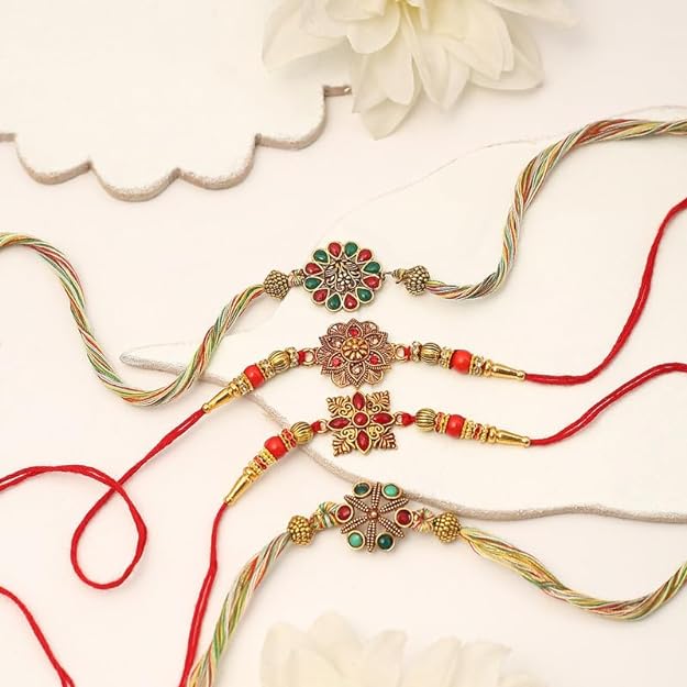 Four elegant rakhi's with intricate gold and red design, perfect for celebrating the bond between siblings.