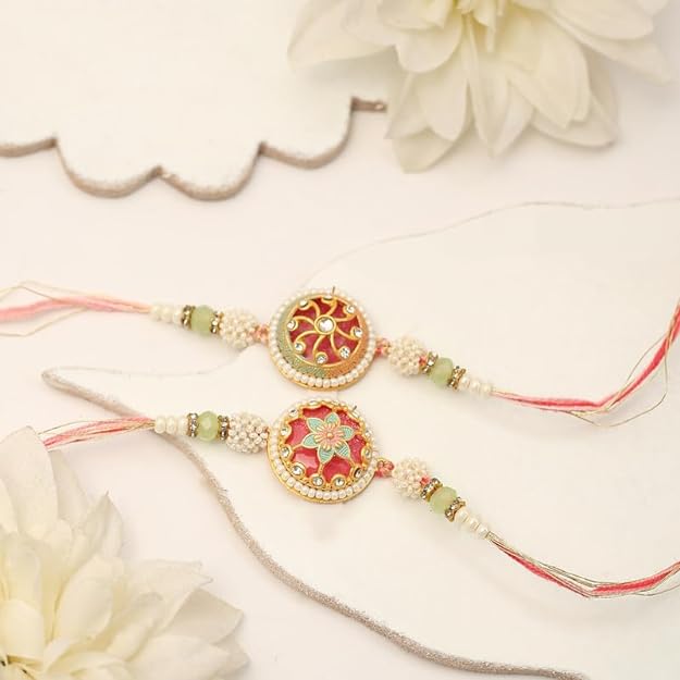 Two rakhi with pink and green beads, symbolizing love and protection during the festival of Raksha Bandhan