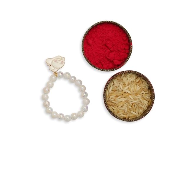 Red powder and white rakhi  with pearl next to bowl of rice