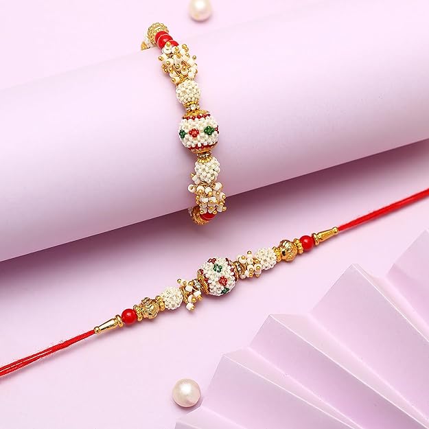  Traditional rakhi bracelets in red and white hues, accented with pearls, representing the special bond between siblings.