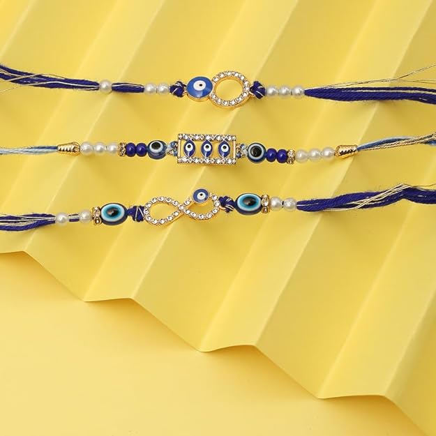 Three beautiful blue rakhi with intricate gold and blue bead detailing, perfect for Raksha Bandhan celebrations.