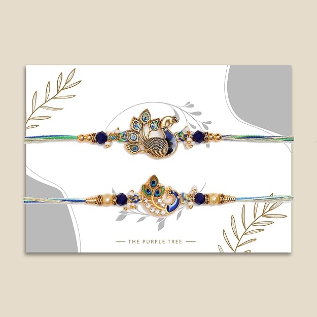 Two gold-plated rakhi bracelets with peacock design and intricate beading.