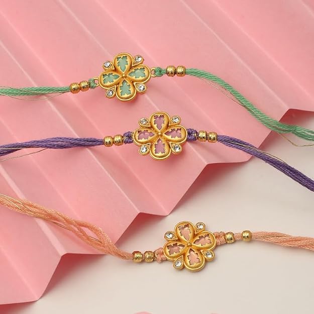 Three colorful rakhi's with gold thread, perfect for celebrating Raksha Bandhan.