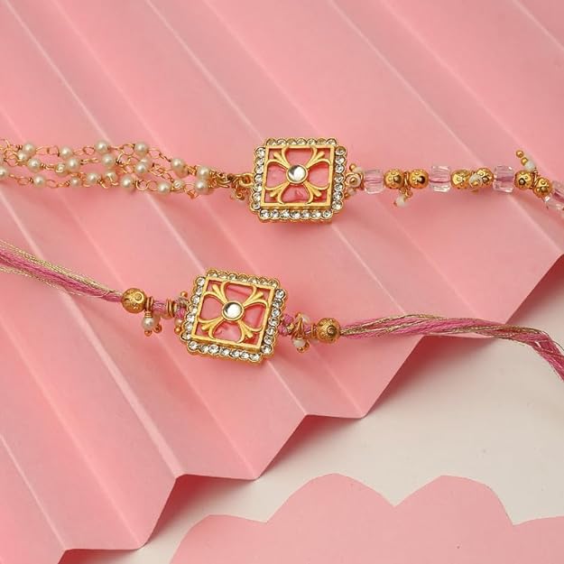 Two pink rakhi's with gold and pearl beads, perfect for celebrating Raksha Bandhan.