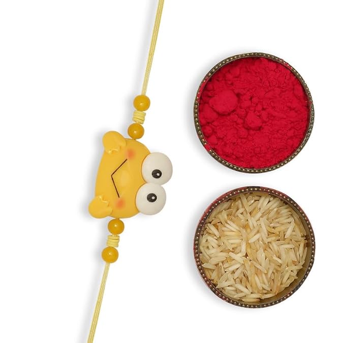 A yellow rakhi with a vermilion and a bowl of  rice, symbolizing the festive celebration of Raksha Bandhan.