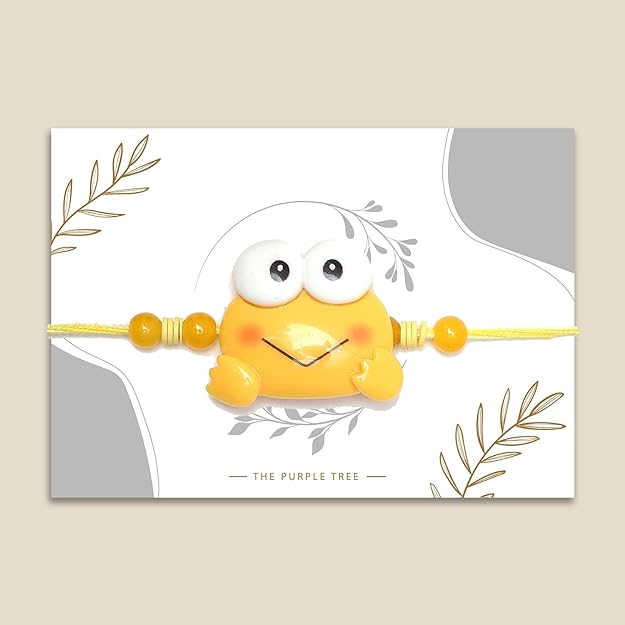 Yellow frog Rakhi with a smiley face, exuding a playful and joyful vibe.