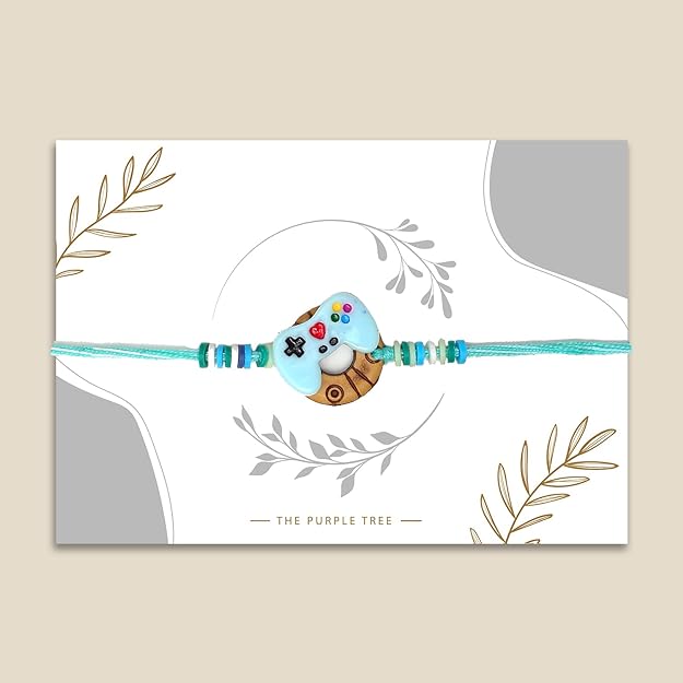 Blue and white button charm hanging from a rakhi